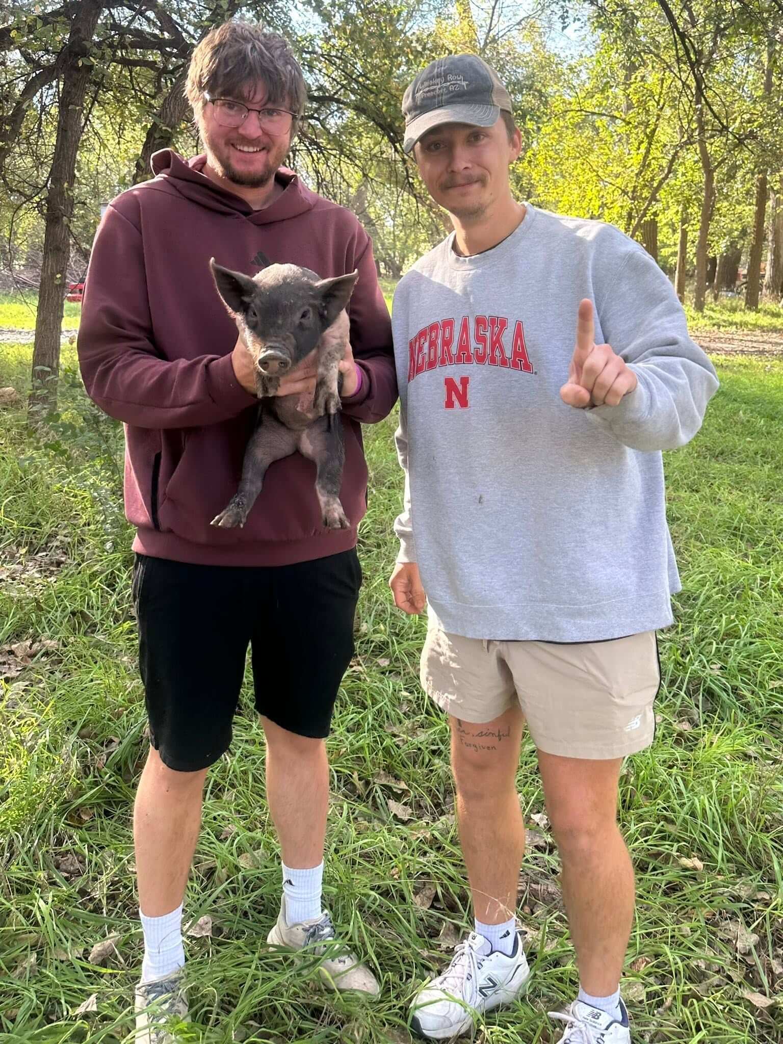 Robin and his brother wrangling a pig